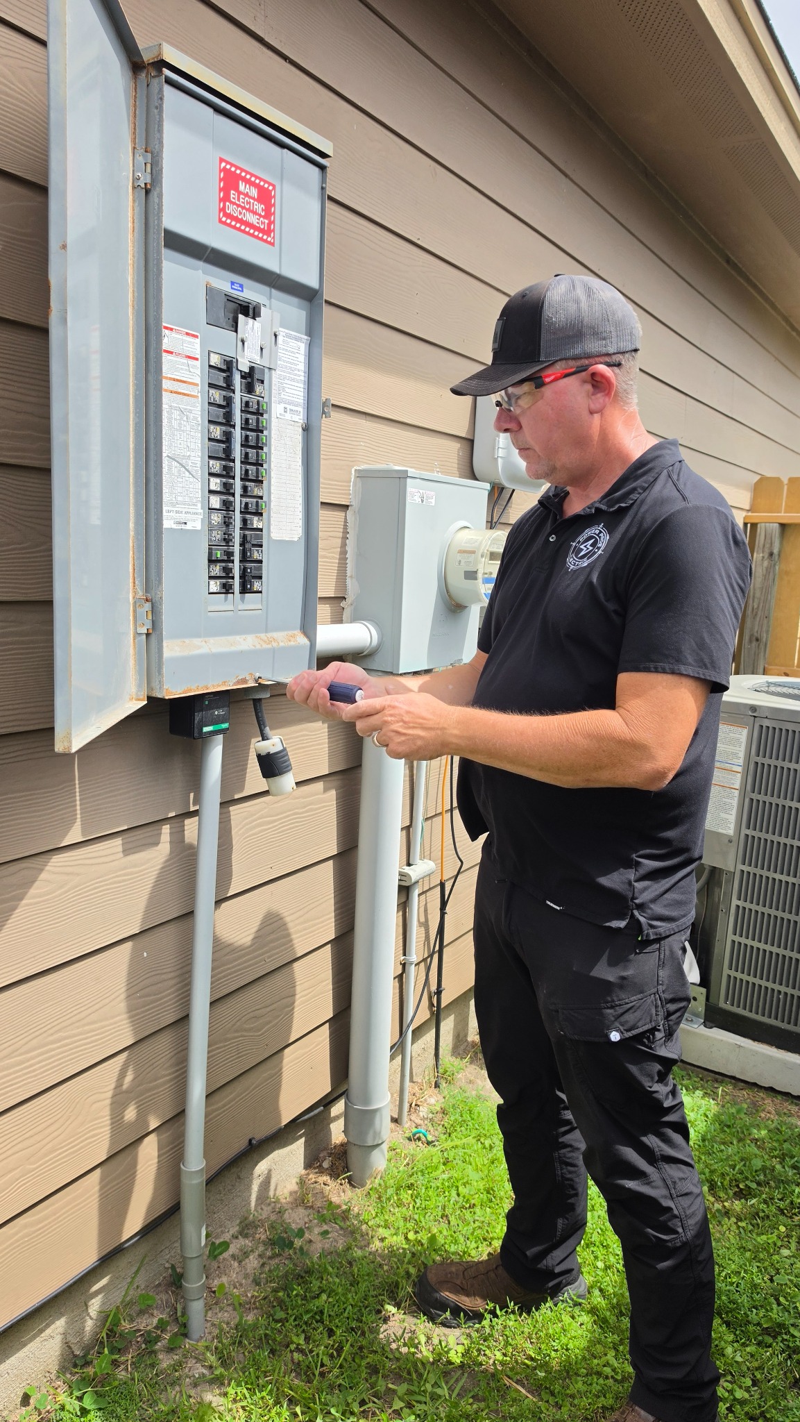 Power Pros Electric owner inspecting a residential electrical panel